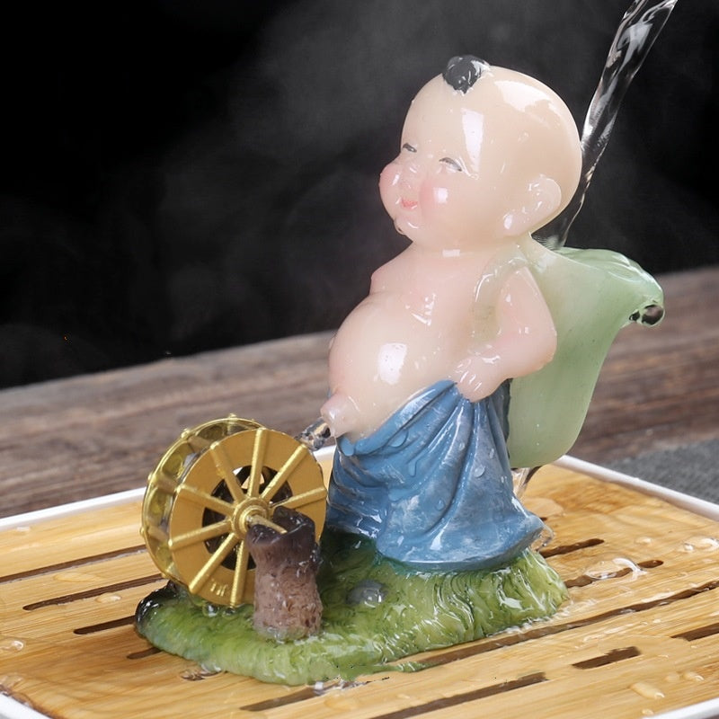 The color-changing tea pet, peeing baby and child, water-spraying tea toy, and the kung Fu tea set symbolize a continuous flow of wealth