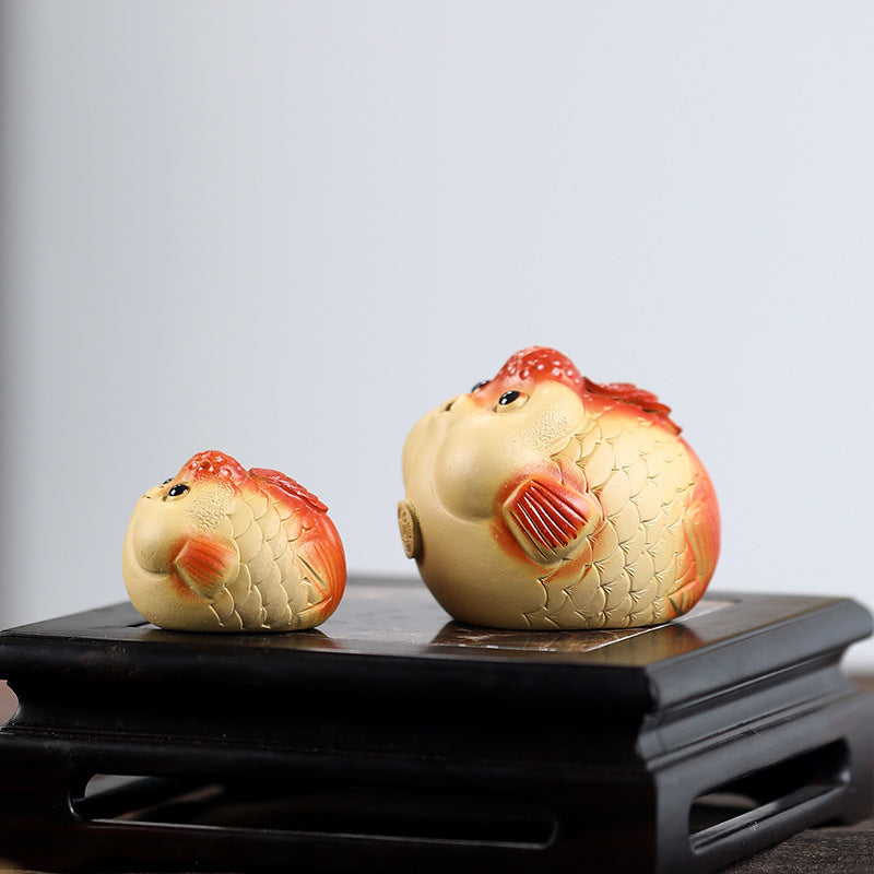 A cute and fun tea toy and tea pet featuring a small purple clay goldfish sputting bubbles, an incense tray, and a tea table decoration