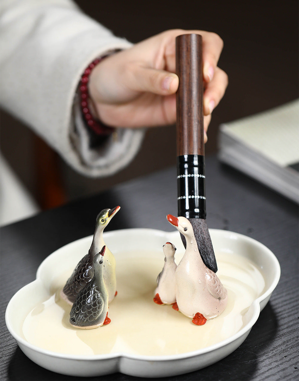 A pair of couple swan ceramic sculpture tea tray ornaments made of Yixing purple clay with color-changing tea pets