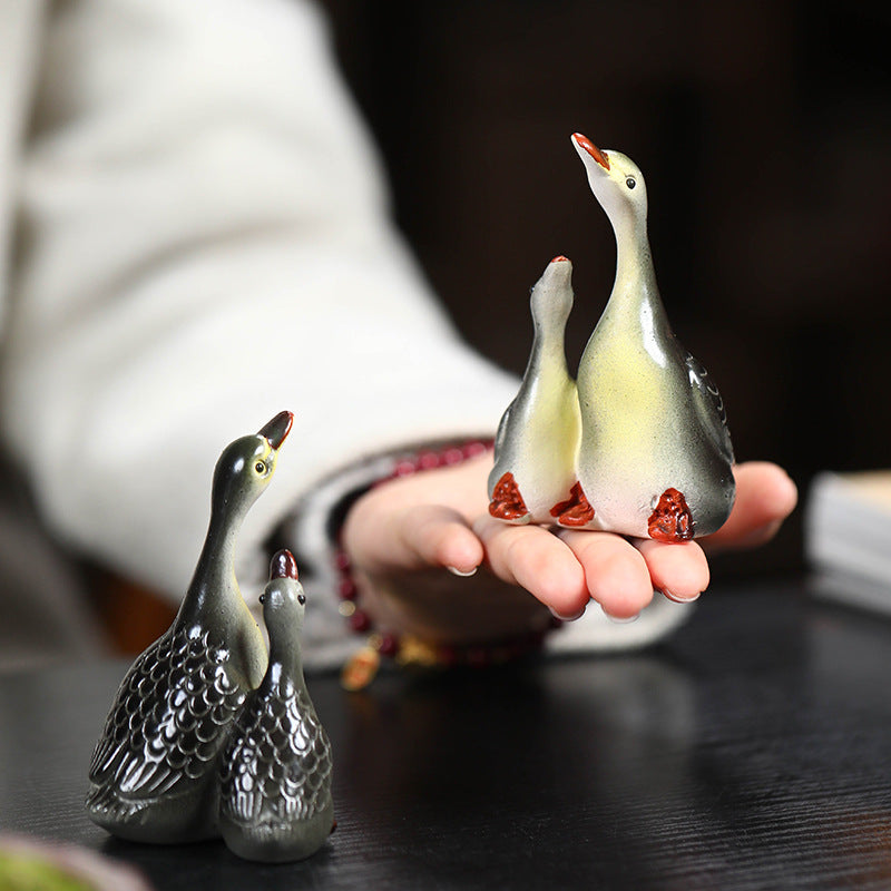 A pair of couple swan ceramic sculpture tea tray ornaments made of Yixing purple clay with color-changing tea pets