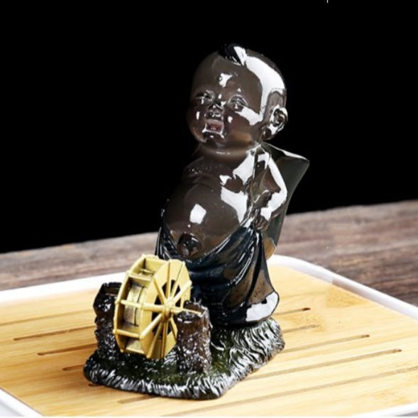 The color-changing tea pet, peeing baby and child, water-spraying tea toy, and the kung Fu tea set symbolize a continuous flow of wealth