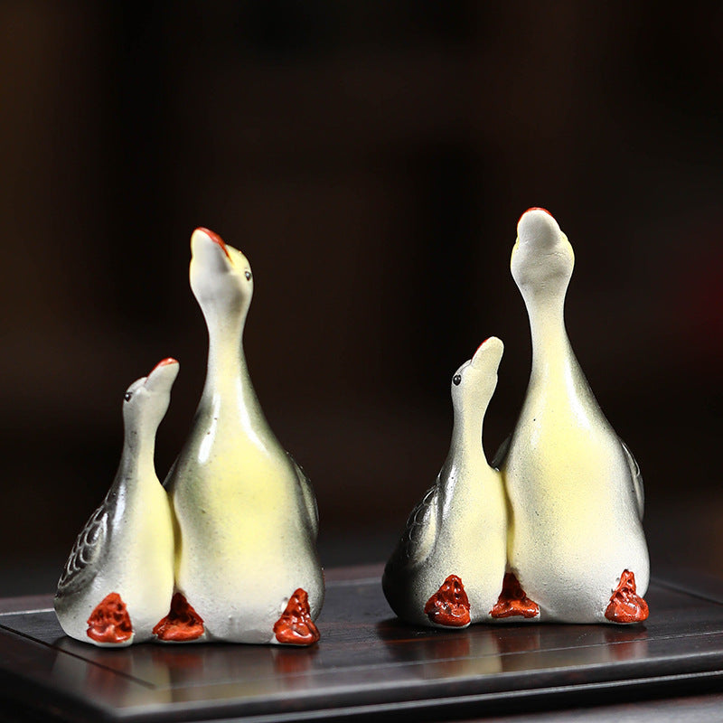 A pair of couple swan ceramic sculpture tea tray ornaments made of Yixing purple clay with color-changing tea pets