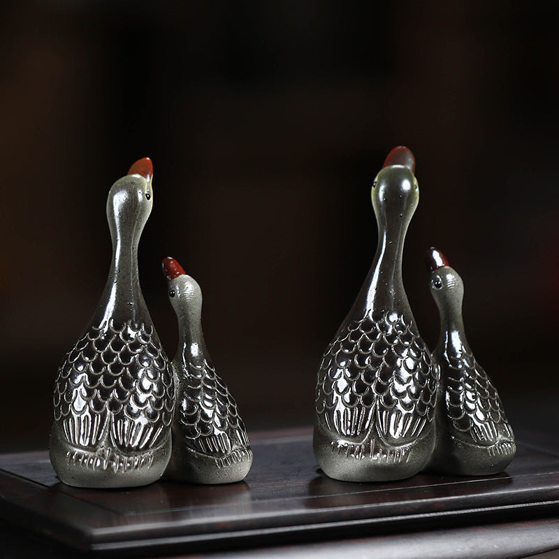 A pair of couple swan ceramic sculpture tea tray ornaments made of Yixing purple clay with color-changing tea pets