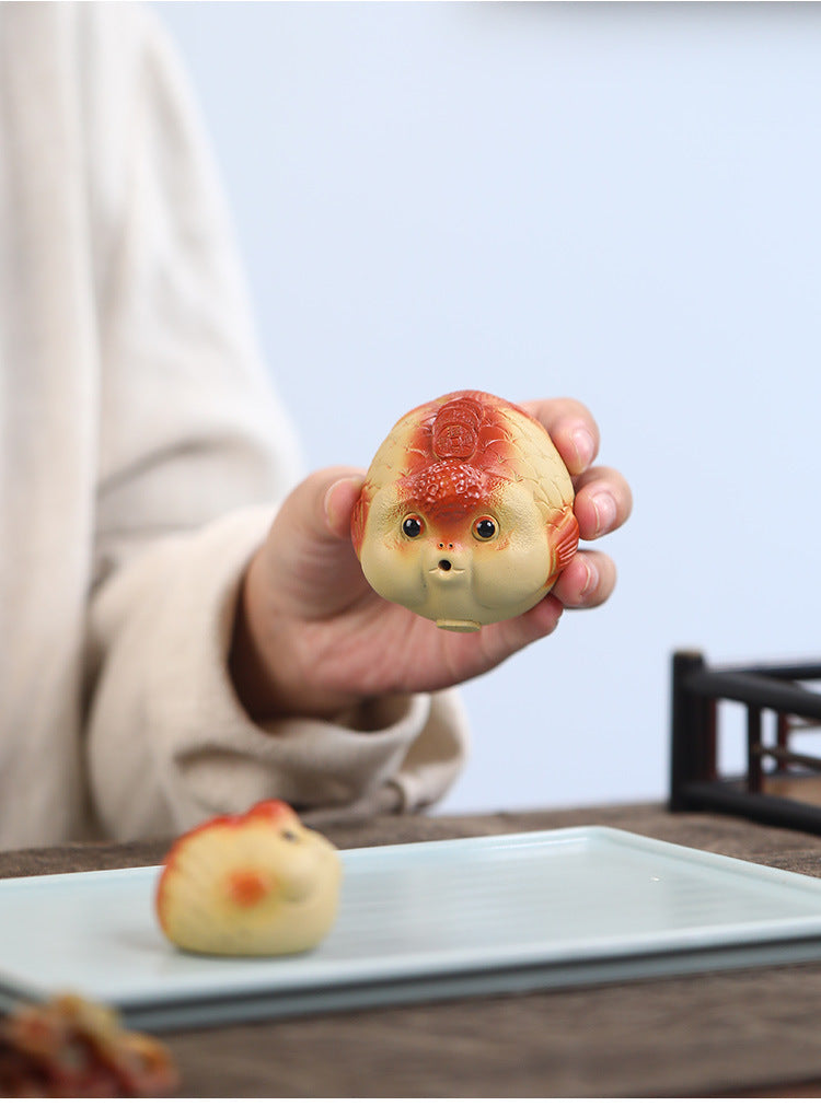 A cute and fun tea toy and tea pet featuring a small purple clay goldfish sputting bubbles, an incense tray, and a tea table decoration
