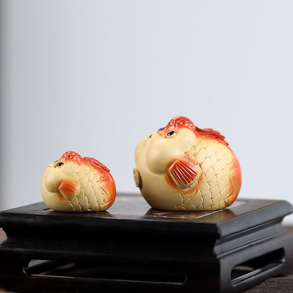 A cute and fun tea toy and tea pet featuring a small purple clay goldfish sputting bubbles, an incense tray, and a tea table decoration