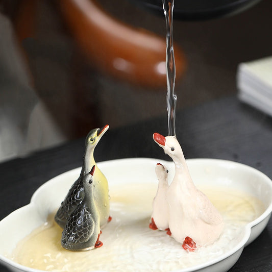 A pair of couple swan ceramic sculpture tea tray ornaments made of Yixing purple clay with color-changing tea pets