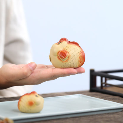 A cute and fun tea toy and tea pet featuring a small purple clay goldfish sputting bubbles, an incense tray, and a tea table decoration
