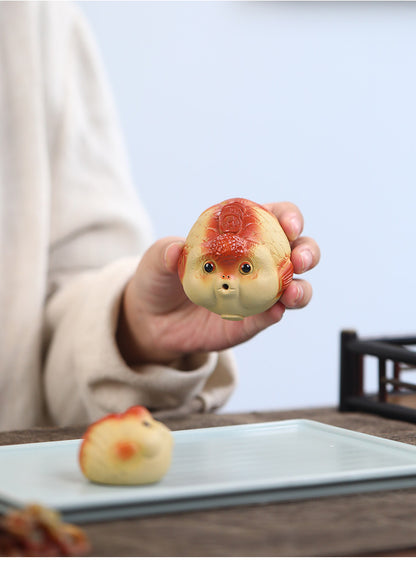 A cute and fun tea toy and tea pet featuring a small purple clay goldfish sputting bubbles, an incense tray, and a tea table decoration